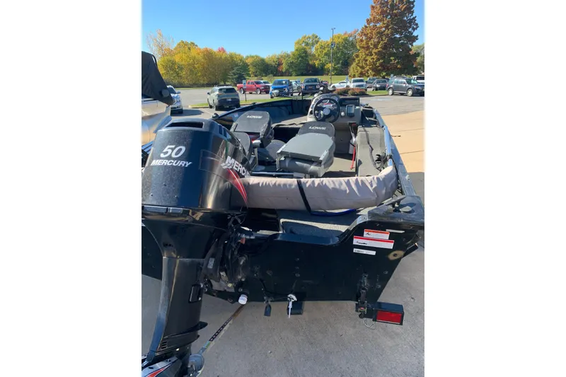 Slide: The Image of 2010 Lowe Fishing Machine 165 with Mercury 50 engine, parked outdoors. - 3