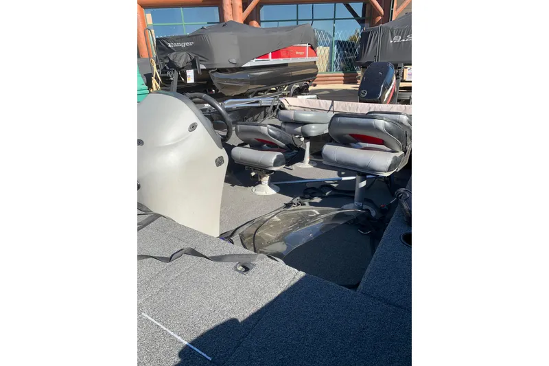 Slide: The Image of 2010 Lowe Fishing Machine 165 interior with seating and steering wheel. - 5