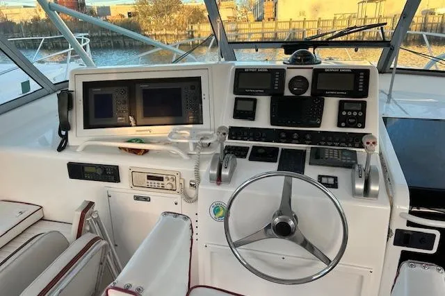 Slide: The Image of 1997 Viking 43 Express boat helm with navigation equipment and steering wheel. - 4