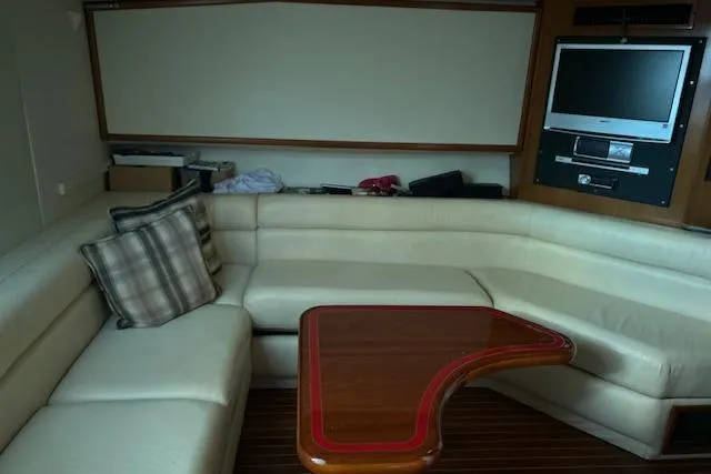 Slide: The Image of Luxurious interior of a 1997 Viking 43 Express yacht with plush seating and a TV. - 5