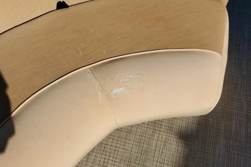 Slide: The Image of Damaged beige upholstery on 2001 Crestliner LSi 2485 I/O boat seat. - 5
