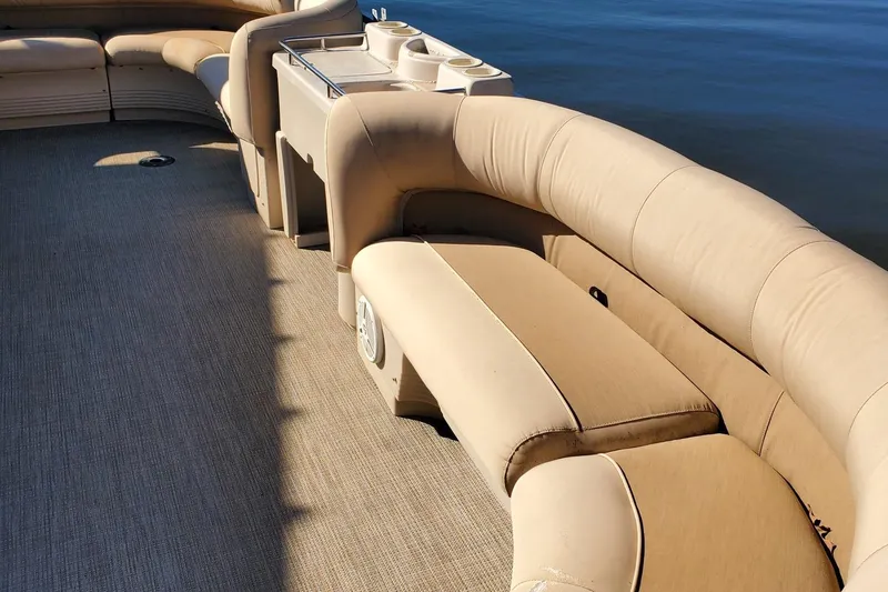 Slide: The Image of 2001 Crestliner LSi 2485 I/O boat interior with beige seating and cup holders. - 6