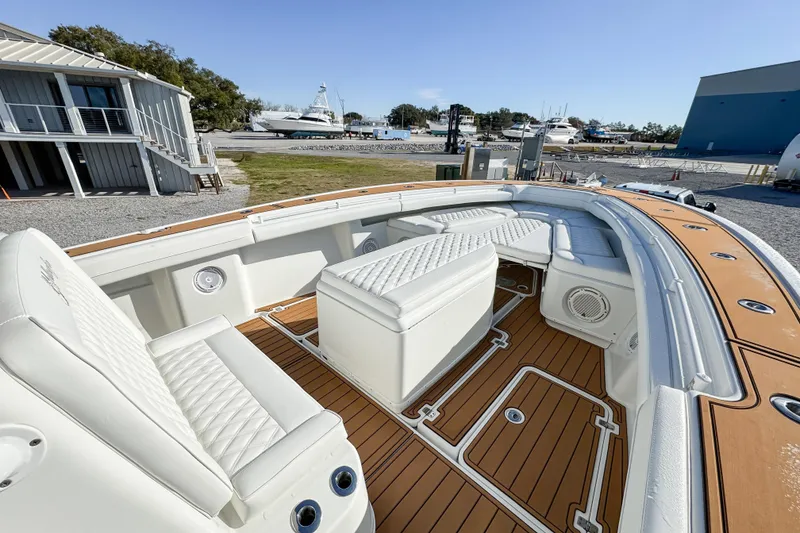 Slide: The Image of 2012 Yellowfin 39 Offshore boat with spacious seating and teak deck, docked at a marina. - 10