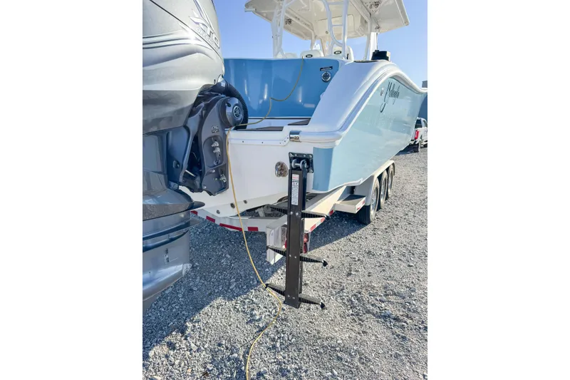 Slide: The Image of 2012 Yellowfin 39 Offshore boat on trailer, parked on gravel. - 15
