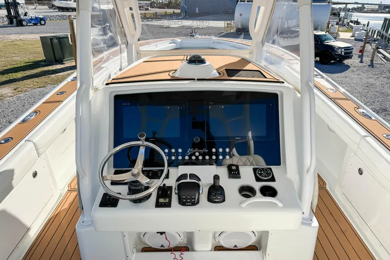Slide: The Image of 2012 Yellowfin 39 Offshore boat helm with modern controls and navigation system. - 5