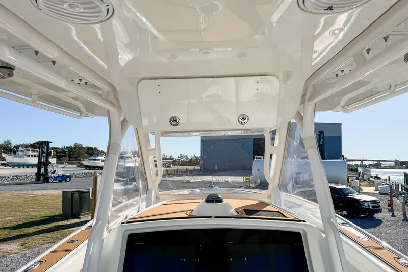 Slide: The Image of 2012 Yellowfin 39 Offshore boat interior view with clear skies and marina background. - 6