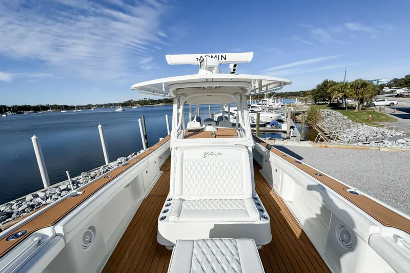 Slide: The Image of 2012 Yellowfin 39 Offshore boat docked by a scenic waterfront. - 8