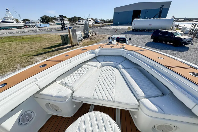 Slide: The Image of 2012 Yellowfin 39 Offshore boat with spacious seating, docked near a marina. - 9