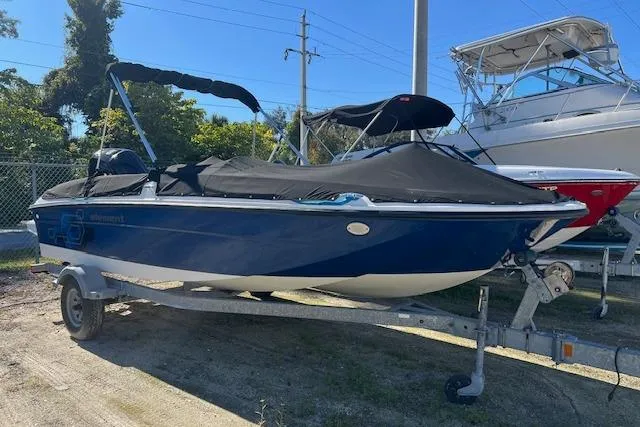 The Image of 2020 Bayliner Element E18 boat with cover on trailer, parked outdoors. - 0