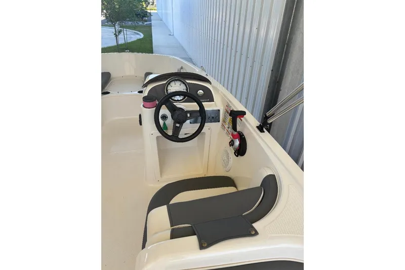 Slide: The Image of 2020 Bayliner Element E18 boat interior with steering wheel and controls. - 4
