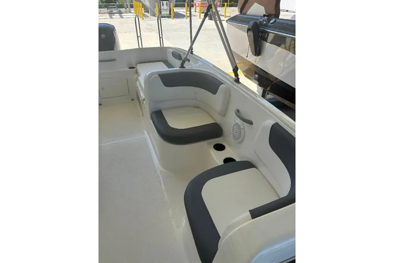 Slide: The Image of 2020 Bayliner Element E18 boat interior with cushioned seating and cup holders. - 5