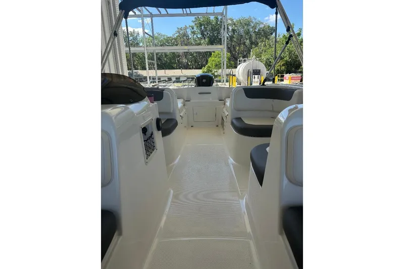 Slide: The Image of 2020 Bayliner Element E18 boat interior with seating and canopy. - 6