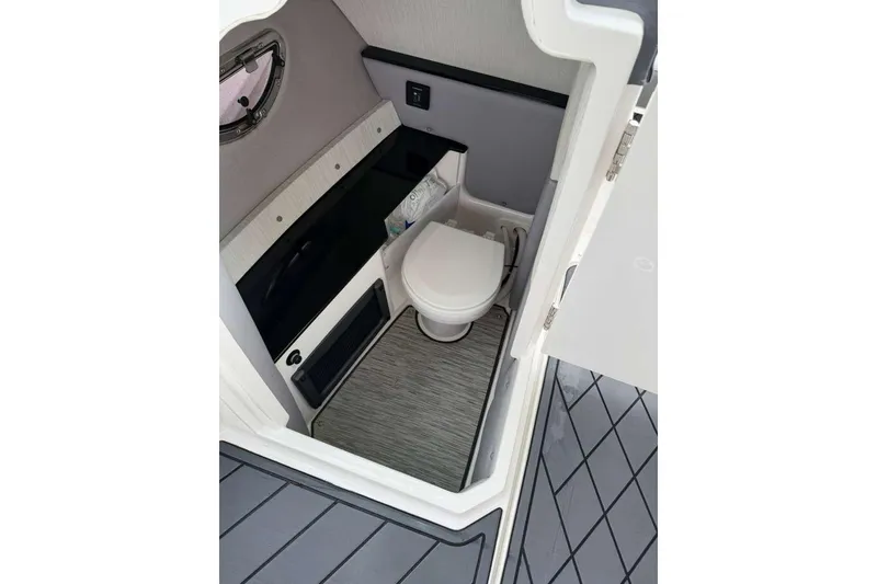 Slide: The Image of 2021 Cobalt R6 boat interior with compact bathroom and toilet. - 11