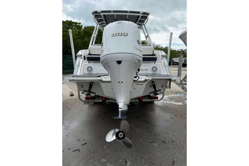 Slide: The Image of 2021 Cobalt R6 boat with powerful outboard motor, parked on a wet surface. - 3