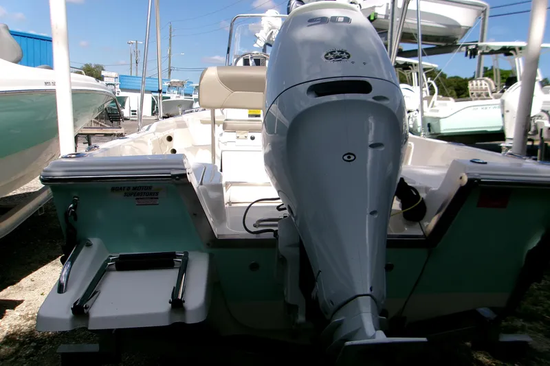 Slide: The Image of 2024 Key West 1720 Center Console boat with powerful outboard motor, docked outdoors. - 10