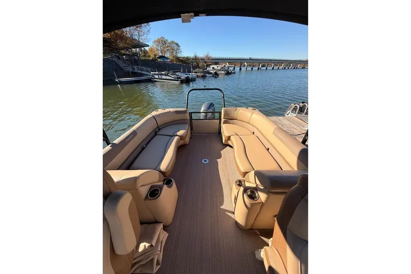 Slide: The Image of 2023 Veranda Relax VR22RC pontoon boat with tan seating, docked by a serene lake. - 10