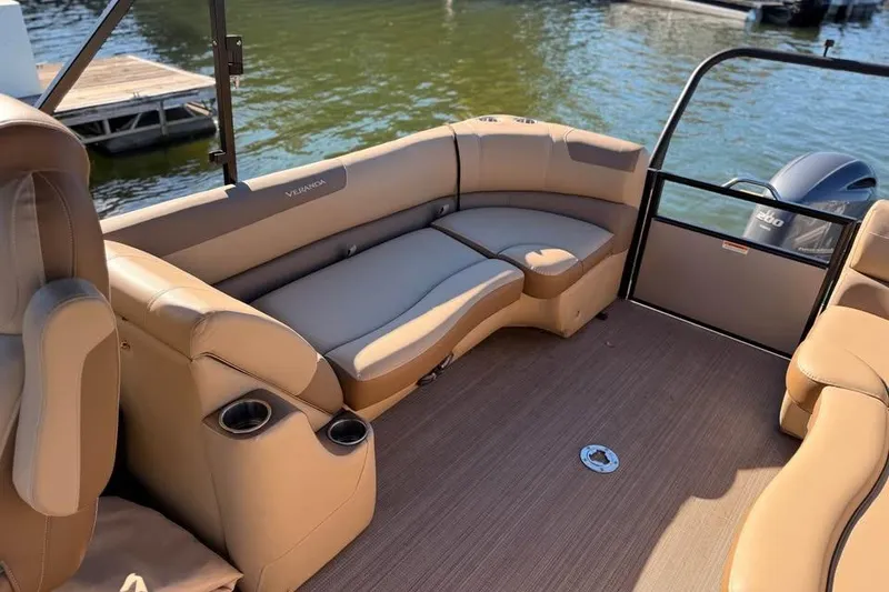 Slide: The Image of 2023 Veranda Relax VR22RC pontoon boat interior with tan seating and cup holders. - 12