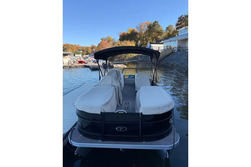 Slide: The Image of 2023 Veranda Relax VR22RC pontoon boat docked on a serene lake. - 13