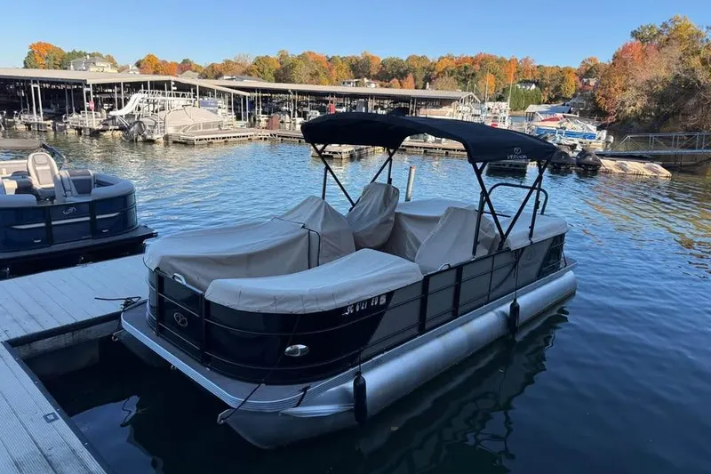 Slide: The Image of 2023 Veranda Relax VR22RC pontoon boat docked at a marina with autumn foliage. - 14