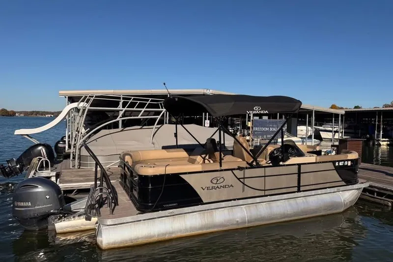 Slide: The Image of 2023 Veranda Relax VR22RC pontoon boat docked, featuring Yamaha engines and a sleek design. - 3