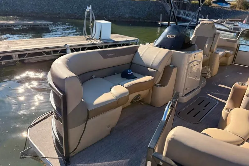 Slide: The Image of 2023 Veranda Relax VR22RC pontoon boat with beige seating, docked by the water. - 5