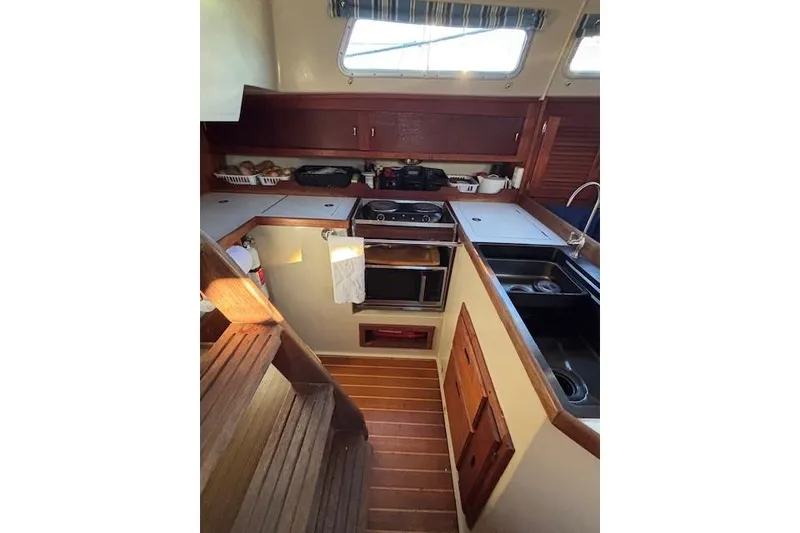 Slide: The Image of 1986 Catalina 36 MK I sailboat on land with ladder and blue hull. - 10