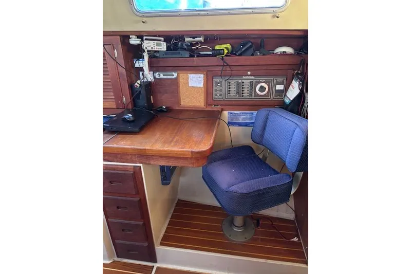 Slide: The Image of Interior of 1986 Catalina 36 MK I sailboat, featuring wooden cabinetry and compact kitchen area. - 13