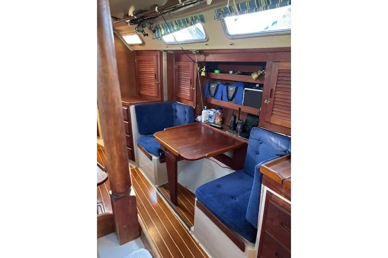 Slide: The Image of Interior of 1986 Catalina 36 MK I sailboat, featuring a cozy kitchen and seating area. - 14
