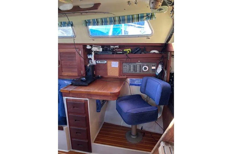 Slide: The Image of 1986 Catalina 36 MK I yacht interior kitchen with wooden cabinetry and compact design. - 16