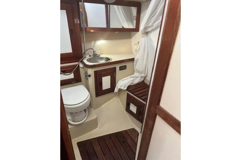 Slide: The Image of Interior of 1986 Catalina 36 MK I sailboat with wooden table and blue seating. - 19