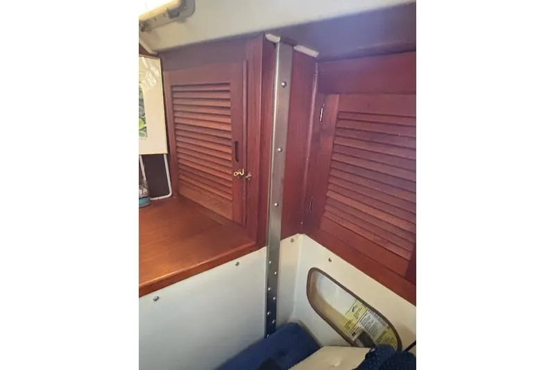 Slide: The Image of Navigation station inside 1986 Catalina 36 MK I sailboat with blue chair and wooden desk. - 24