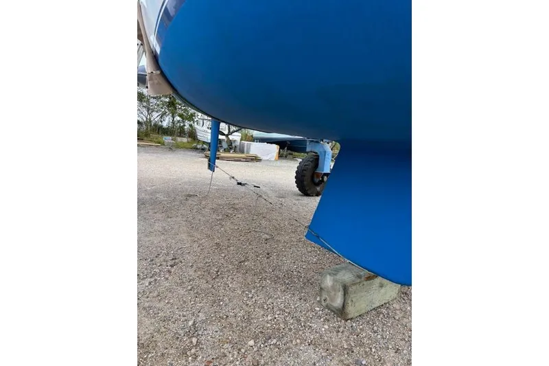 Slide: The Image of 1986 Catalina 36 sailboat docked at marina with ropes and equipment visible. - 3