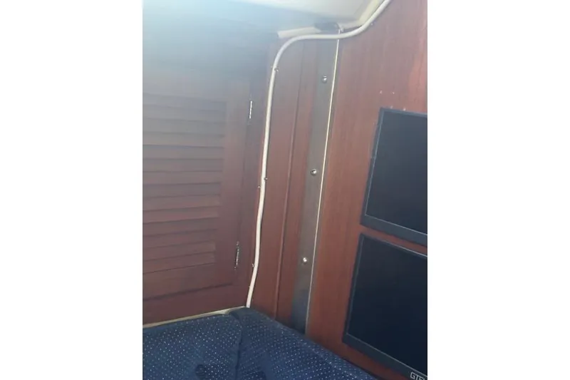 Slide: The Image of Interior of 1986 Catalina 36 MK I sailboat with wood paneling and blue upholstery. - 35