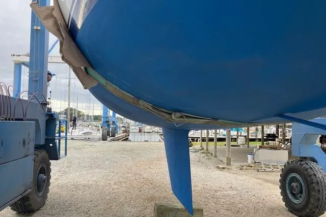 Slide: The Image of 1986 Catalina 36 sailboat deck view at marina, featuring mast and rigging. - 4