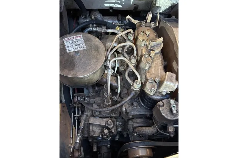 Slide: The Image of Catalina 36 MK I 1986 engine compartment with visible components and caution label. - 41