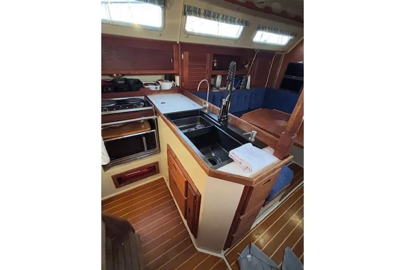 Slide: The Image of 1986 Catalina 36 sailboat docked at marina during sunset. - 7