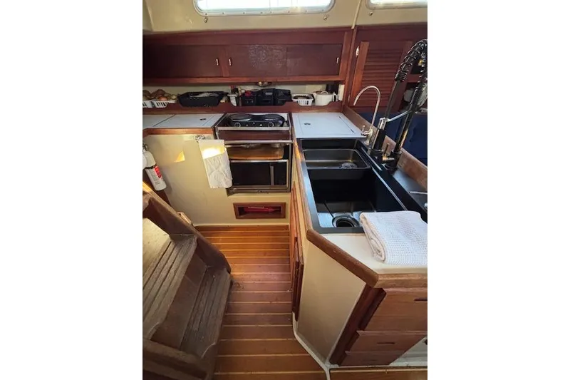 Slide: The Image of 1986 Catalina 36 MK I sailboat on stands, clear sky background. - 9