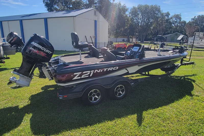 Slide: The Image of 2017 Nitro Z21 Pro bass boat with Mercury engine on grassy area. - 5