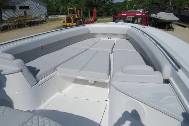 Slide: The Image of 2024 HCB 53 Suenos RXV boat with spacious white seating area. - 17