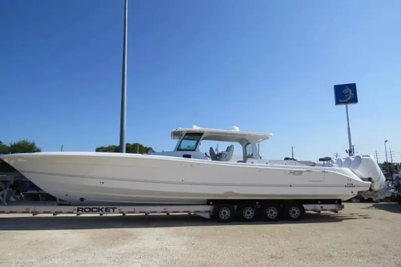 The Image of 2024 HCB 53 Suenos RXV boat on trailer under clear blue sky. - 0