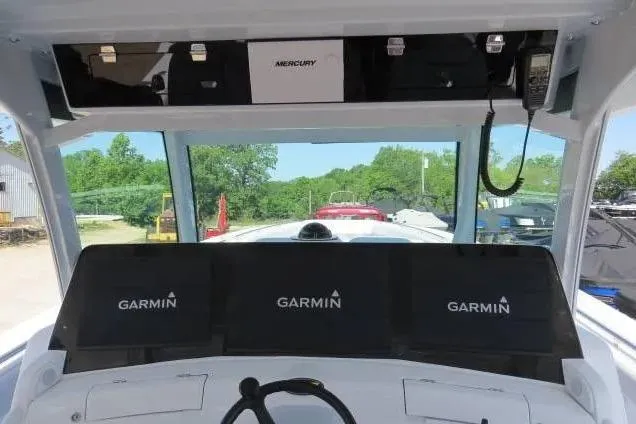 Slide: The Image of 2024 HCB 53 Suenos RXV boat cockpit with Garmin displays and Mercury equipment. - 14