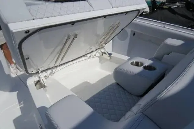 Slide: The Image of 2024 HCB 53 Suenos RXV boat interior with open storage and cup holders. - 21