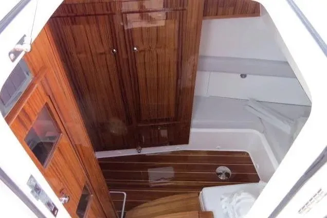 Slide: The Image of 2024 HCB 53 Suenos RXV cabin interior with wooden cabinetry and flooring. - 22