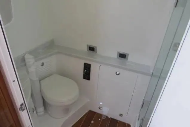 Slide: The Image of 2024 HCB 53 Suenos RXV boat bathroom with modern fixtures and wooden flooring. - 27