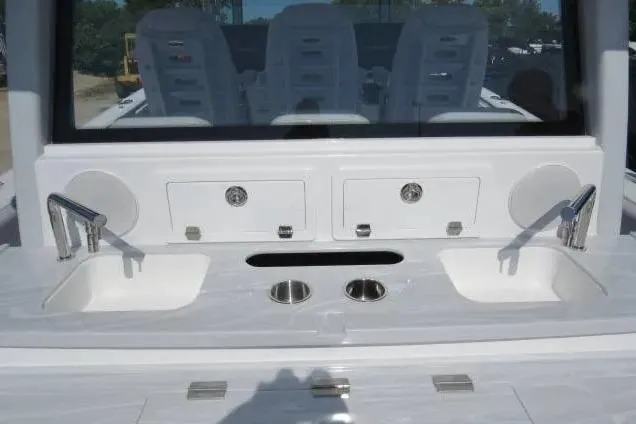 Slide: The Image of 2024 HCB 53 Suenos RXV boat interior with dual sinks and storage compartments. - 7