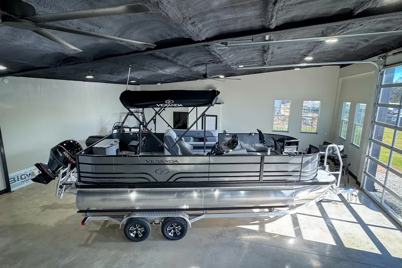 Slide: The Image of 2026 Veranda Vista 20F4 pontoon boat displayed indoors on a trailer. - 19