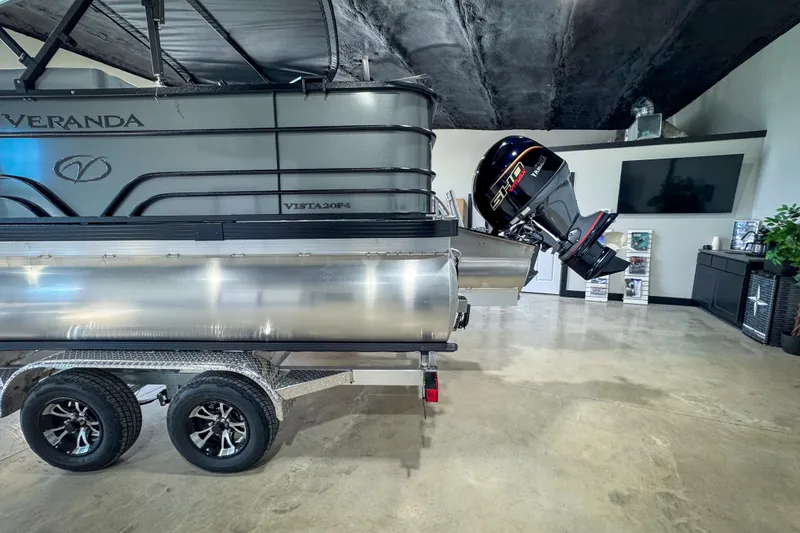 Slide: The Image of 2026 Veranda Vista 20F4 pontoon boat on trailer in showroom. - 4