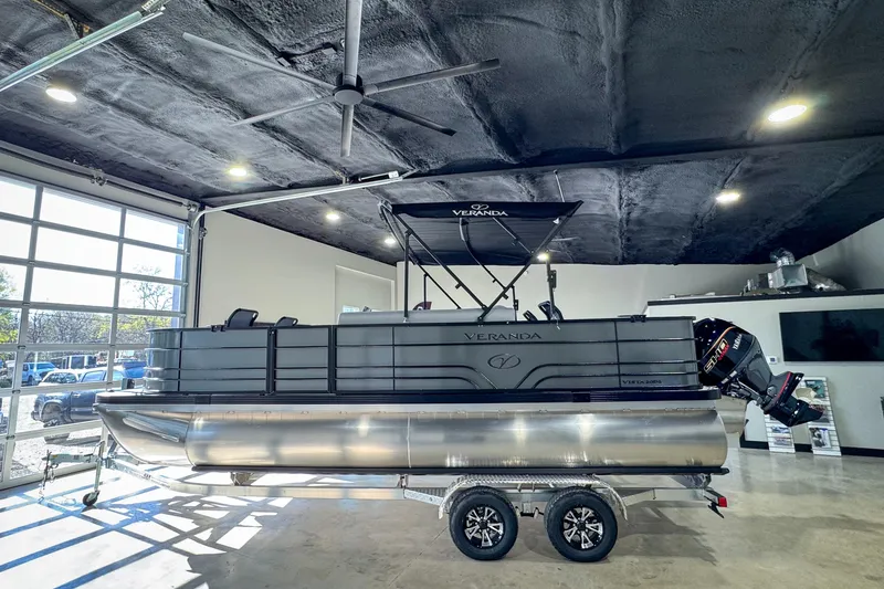 Slide: The Image of 2026 Veranda Vista 20F4 pontoon boat displayed indoors on a trailer. - 5