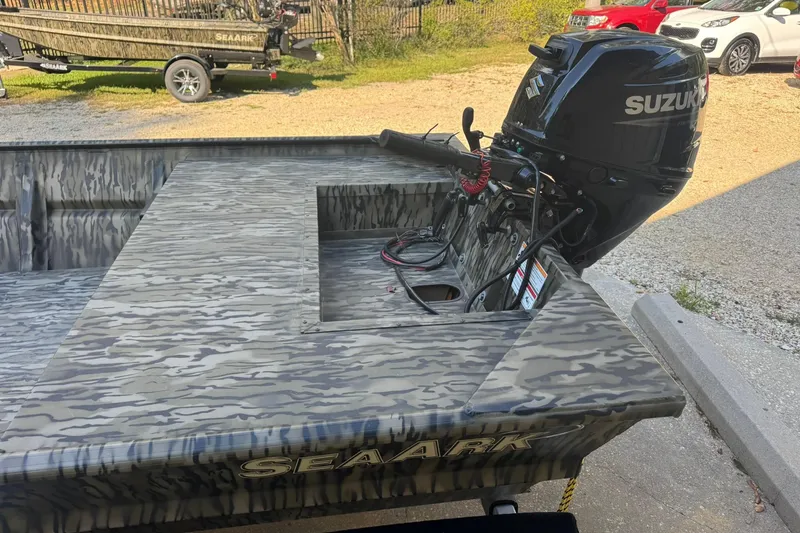 Slide: The Image of 2025 SeaArk 1648 MV Special boat with Suzuki outboard motor, camo design. - 17