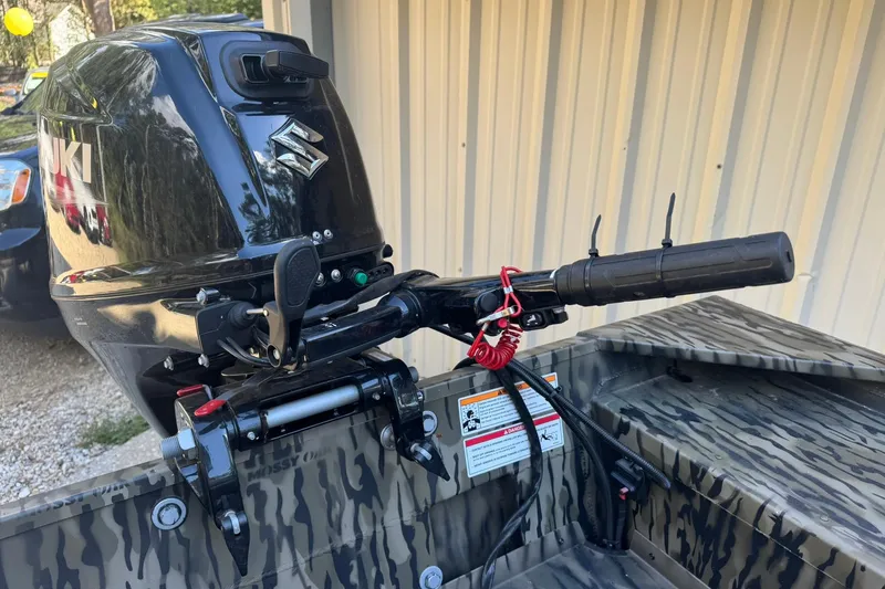 Slide: The Image of 2025 SeaArk 1648 MV Special boat with Suzuki outboard motor, camo design, and safety features. - 19